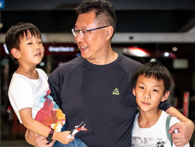 Jason photographed with his sons Andrew &amp; Thomas Kao arriving at Sydney airport after being held in quarantine in Darwin. Picture: Monique Harmer