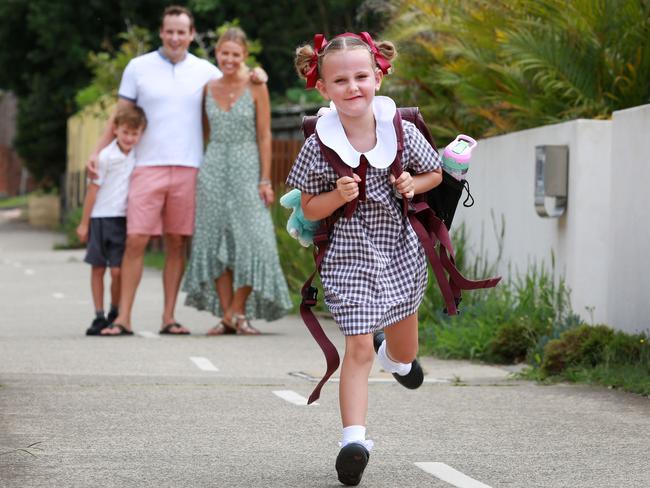 Olive O'Hagan, who has a cochlear implant, is starting school in Manly next week. Her parents Adrian and Rachel an brother Aengus, 8, are pictured behind her. Picture: Mark Scott.