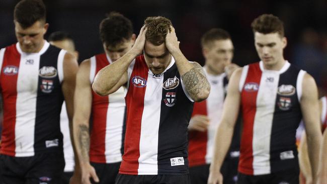 Dejected St Kilda players leave the field after their loss to Brisbane Lions. Picture: AAP Image/Daniel Pockett.