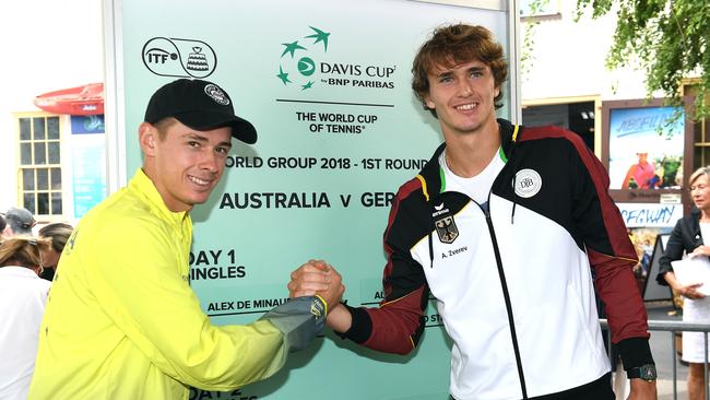 Australian Alex de Minaur (left) poses for a photograph with Alexander Zverev of Germany during the Davis Cup draw in Brisbane, Thursday, February 1, 2018. The Davis Cup World Group First Round tie between Australia and Germany will take place on hardcourt at Pat Rafter Arena from February 2 to 4. (AAP Image/Dave Hunt) NO ARCHIVING, EDITORIAL USE ONLY