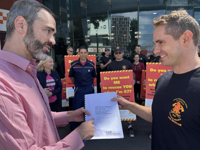 United Firefighters Union of Australia Tasmania Branch Industrial Organiser Stephen McCallum and Workplace Representative Toby Bresnehan looking at the latest report by the Australia Institute’s Centre for Future Work. Picture: Simon McGuire.