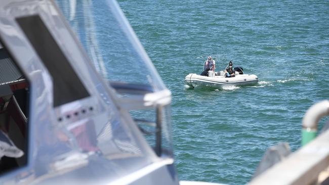 Border Force and biosecurity approach the yacht in Darwin Harbour. Picture: Che Chorley