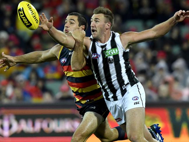 Adelaide captain Taylor Walker battles for the ball against Collingwood’s Lynden Dunn during the Crows’ round four loss at Adelaide Oval. Picture: Sam Wundke (AAP).