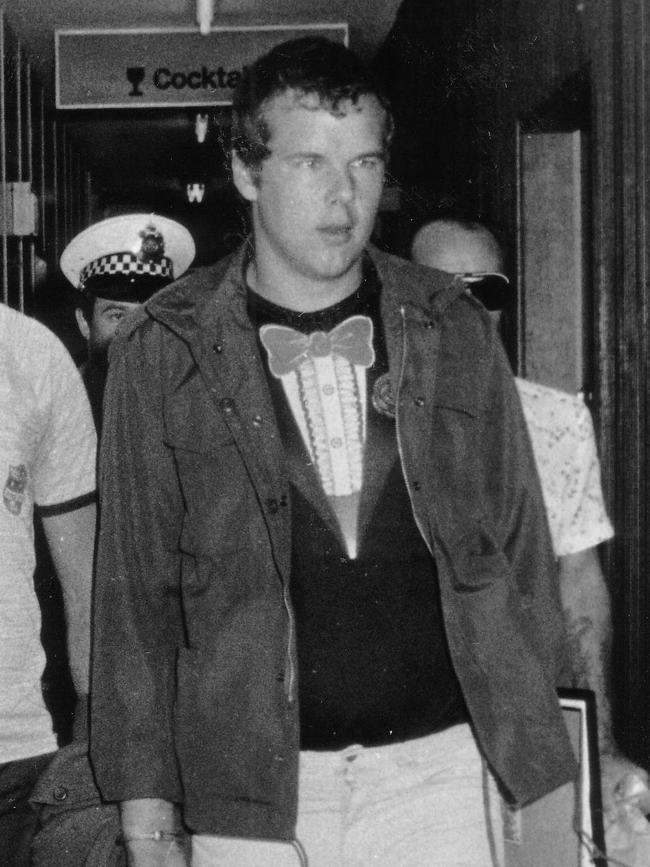 Murderer Andy Albury is led by detectives through the Darwin Airport. Albury was convicted of killing a woman in Darwin's Mitchell Street in November 1983 and mutilating her body.