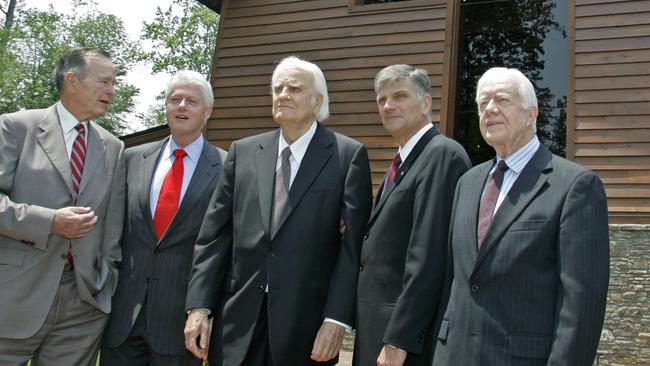 Former Presidents, George H.W. Bush, left, Bill Clinton, second left, and Jimmy Carter, right, join Franklin Graham, second right, as they pose with Billy Graham, centre, in front of the Billy Graham Library in Charlotte, N.C in 2007. Picture; AP.