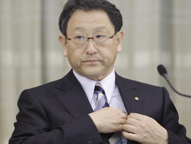 Global boss ... Akio Toyoda leaves the media press conference followed by Max Yasuda, the boss of Toyota Australia, after announcing the end of local production in 2017. Picture: Supplied.