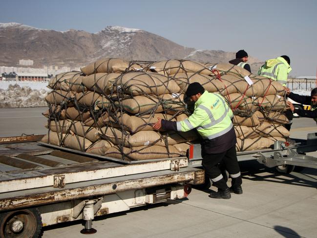 Workers load pine nuts from China into a plane at Kabul International Airport (Photo by Saifurahman Safi/Xinhua via Getty Images)