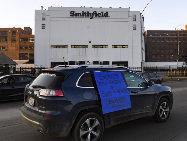 A car with a sign calling for a safe and healthy workplace drives past Smithfield Foods in Sioux Falls, South Dakota. Picture: AP