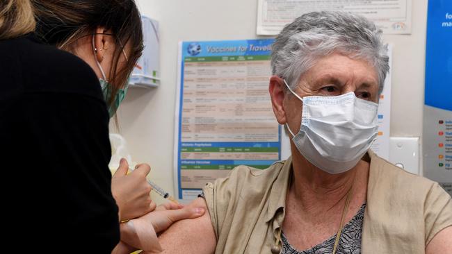 Anne Hyslop receives an AstraZeneca vaccine from practice nurse Youri Park (L) in Melbourne on April 7