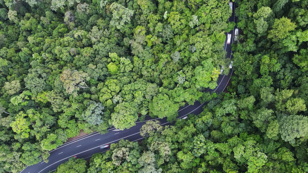 Aerial view of the Kennedy Highway snaking through World Heritage listed rainforest up the McAllister Range. This section of the highway is commonly referred to as the Kuranda Range Road, and is the main transport route from Cairns to the Atherton Tablelands, west to the Gulf and north to Cape York. Thousands of cars, tourist coaches and trucks traverse the Kuranda Range Road each day. The route can be hazardous in wet weather, with the roadway becoming slippery and trees and rocks commonly falling over the road. Picture: Brendan Radke