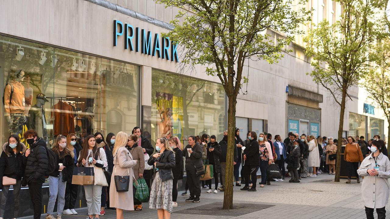 Non-essential shops also reopened with big queues to get into fashion retailer Primark in Liverpool. (Photo by Oli SCARFF / AFP).