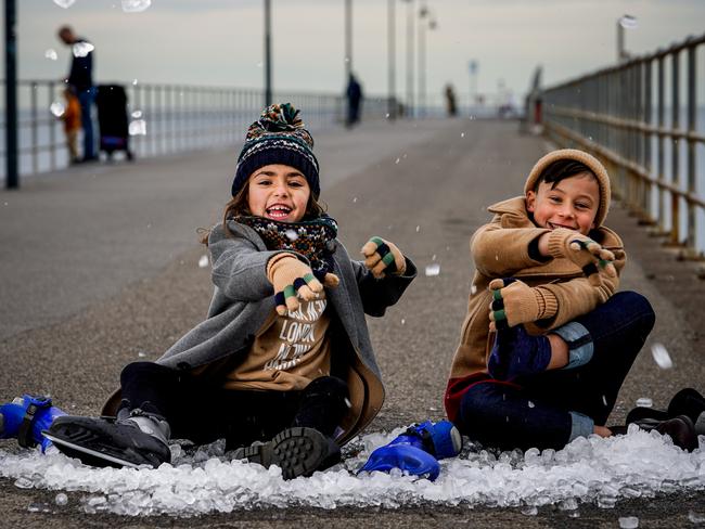 A new winter festival is being launched at Glenelg, Gracie Centenera 8 (dad Paul 0403572500) and George Archontidis 7 get into the spirt with ice and skates on Glenelg Jetty Monday May 31, 2021 - pic Mike Burton