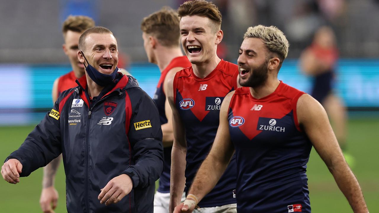 Melbourne coach Simon Goodwin enjoys the win over Adelaide with Bayley Fritsch and Christian Salem.