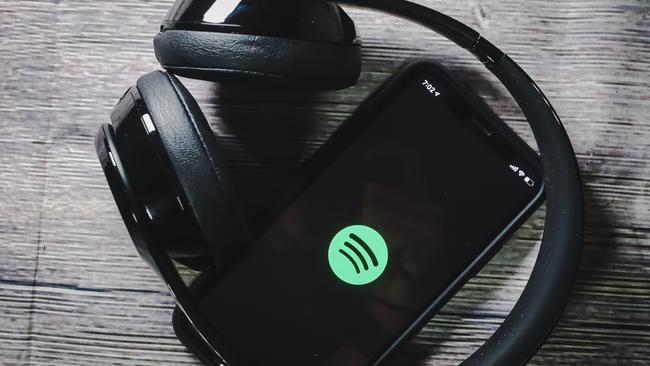 An iphone 11 screen showing spotify icon with beats earphone, perfect for listening musics on the go