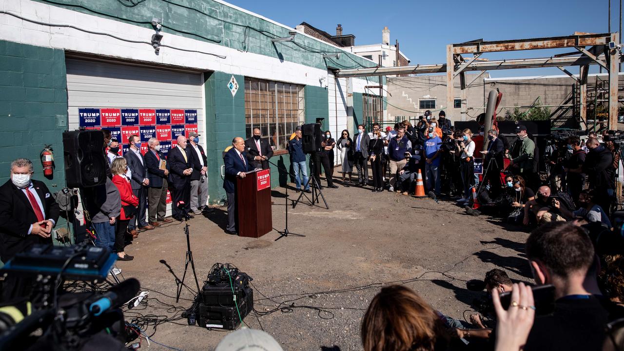 Rudy Giuliani speaks to the media at a press conference held in the back parking lot of landscaping company. Picture: Chris McGrath/Getty Images/AFP