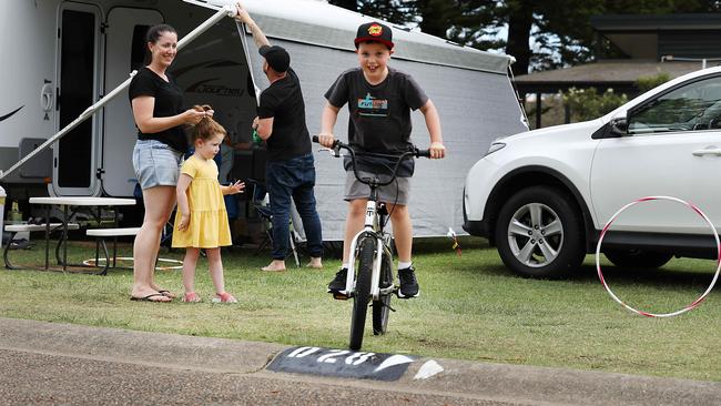 Kylie and Jason Stay, with Chloe and Tyler, make the most of being locked down at a near-deserted Lakeside Caravan Park in Narrabeen, northern Sydney, on Sunday. Picture: Jane Dempster