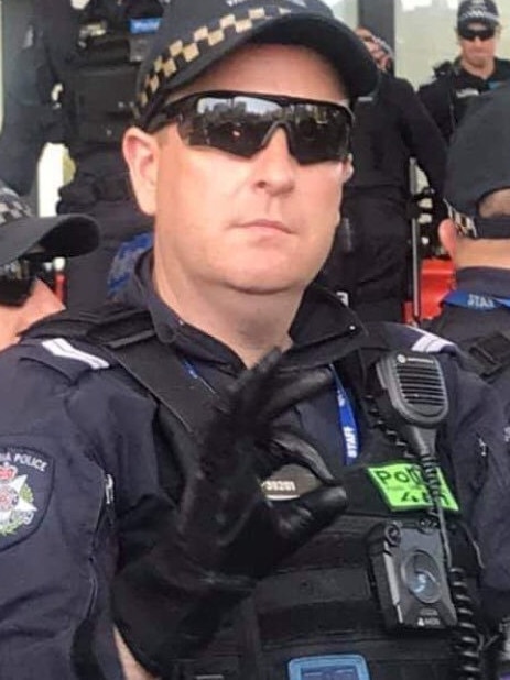 Police officer making a hand signal at protesters at an anti-mining rally on Oct 30. Picture: Nicola Paris/Twitter