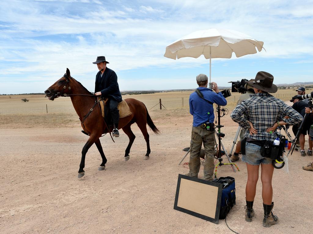 Russell Crowe rides his horse holding a bag in his right hand the whole way in a marathon 24 minute take. Picture: Mark Brake