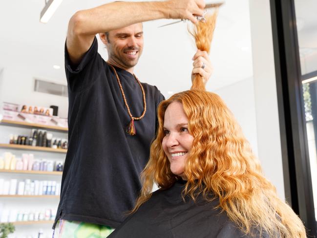 Chris Hunter cutting the hair of Bridgette Birchall at his salon, Willomina, in Sydney’s Woollahra. The salon is excited about the idea of turning waste clippings into such a useful product. Picture: Max Mason-Hubers