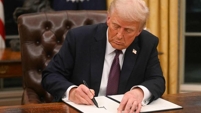 US President Donald Trump signs an executive order in the Oval Office of the White House. Picture: AFP