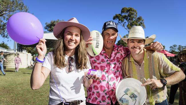 Getting ready for the miniature pig races are (from left) Anthea Beveridge, Cam Moodie and Zac Beveridge at Sadie's Day Out, a special community event to celebrate the life of five-year-old crash victim Sadie, held at Cambooya State School, Saturday, June 7, 2025. Picture: Kevin Farmer