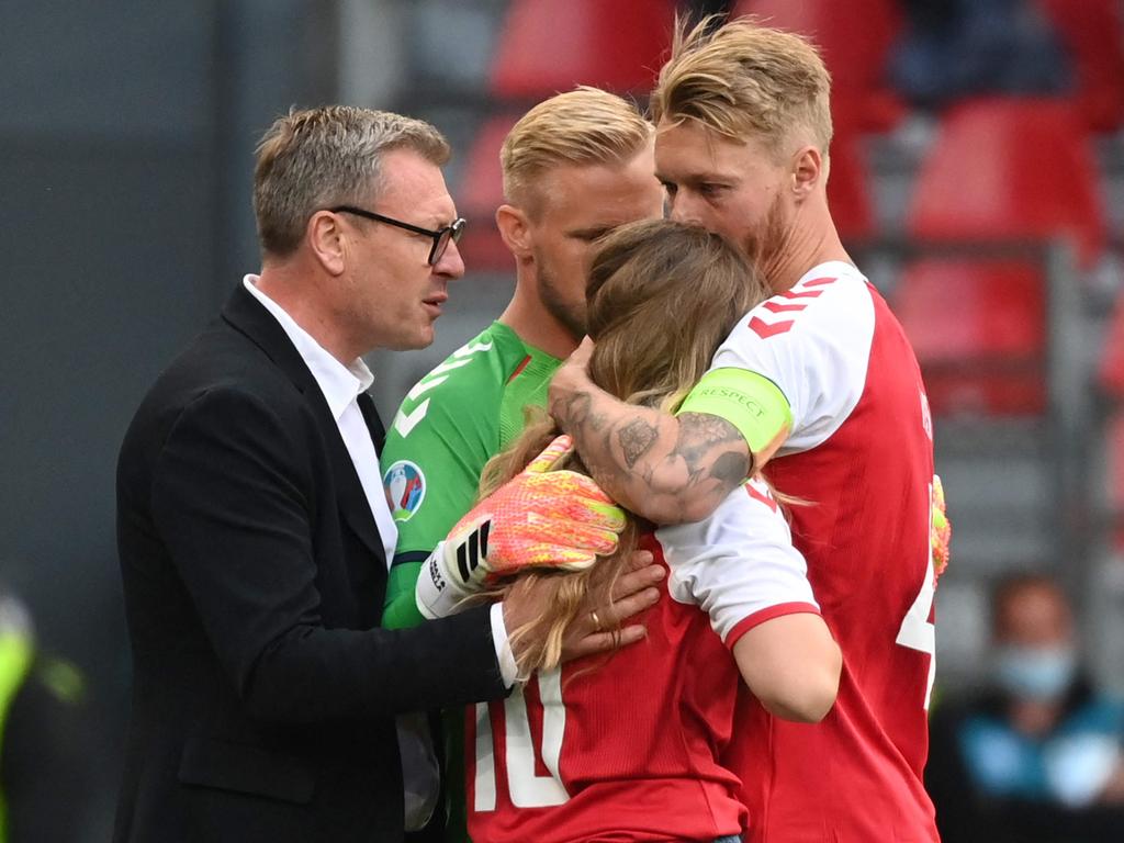 Sabrina Kvist Jensen is embraced by Simon Kjaer.