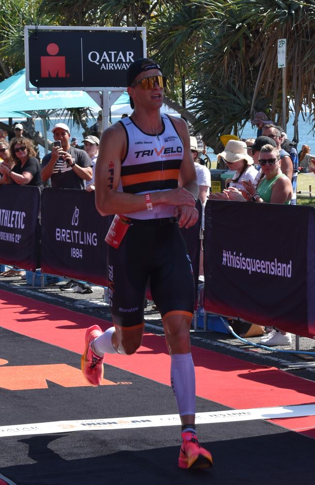 Athletes crossing the finish line at Sunshine Coast Ironman 70.3 2023.