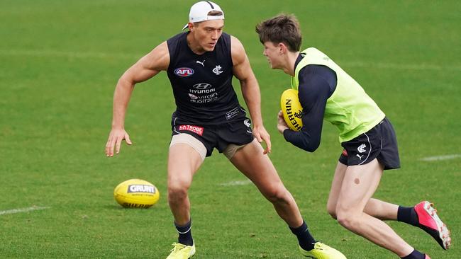 Sam Walsh, right, takes a run at Patrick Cripps during a Carlton training session at Ikon Park on Monday. Picture: AAP