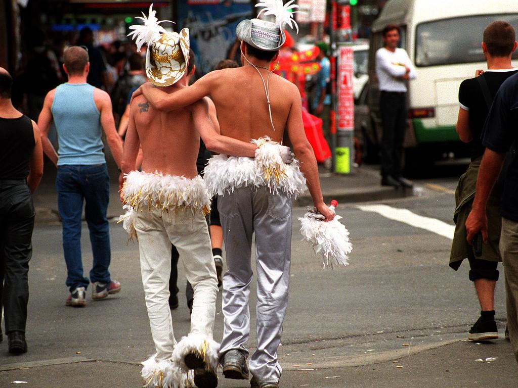 Sydney Gay &amp; Lesbian Mardi Gras revellers walk down Oxford Street on their way home from a recovery party. Picture: Alan Pryke