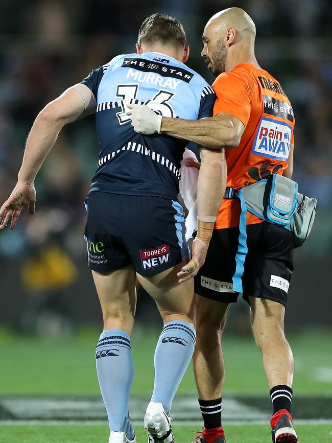 Cameron Murray is assisted from the field. Picture: Getty Images