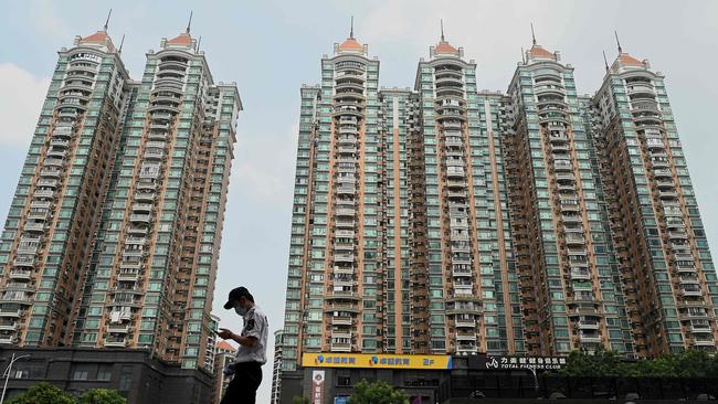 A man walking past a housing complex by Chinese property developer Evergrande in Guangzhou, China's southern Guangdong province. Picture: AFP