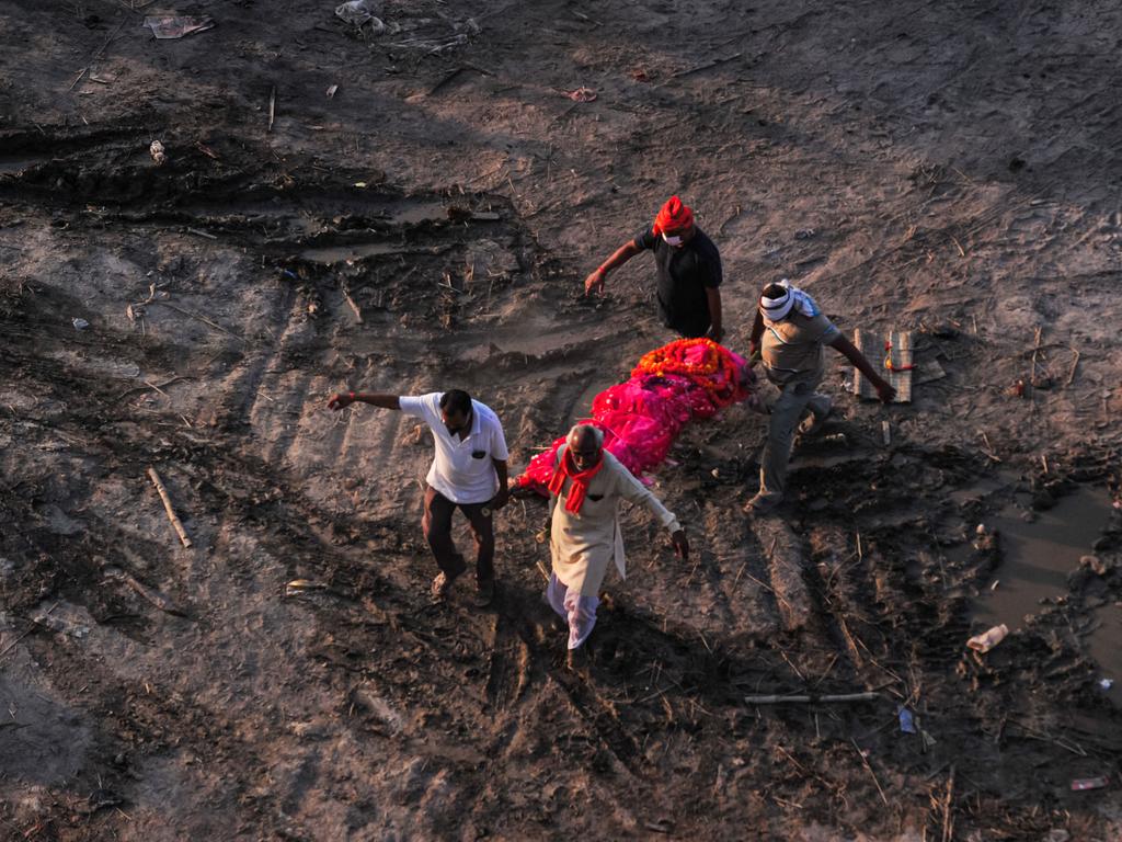 Relatives carry a body of suspected COVID-19 victim to a funeral pyre at a mass crematorium site on the banks of the Ganges river. Picture: Ritesh Shukla/Getty Images