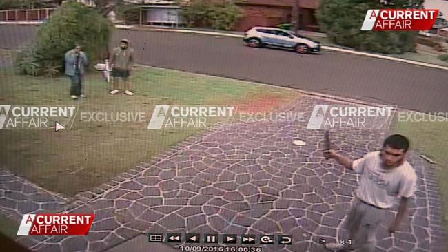 Alleged terror suspect Ihsas Khan (front right) is seen brandishing a large knife in the Sydney suburb of Minto. Picture: A Current Affair/Channel 9
