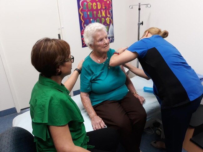 Doctor Harpreet Grover supports Elsie Clarke as nurse Freyja Arroylo administers the COVID vaccination at Gladstone Medical Centre this week.