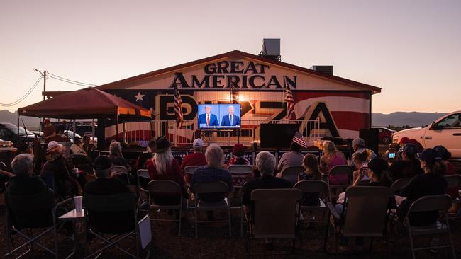 Supporters of US President Donald Trump gather to watch the last presidential debate outside the Great American Pizza and Subs restaurant in Golden Valley, Arizona on October 22. Picture: AFP