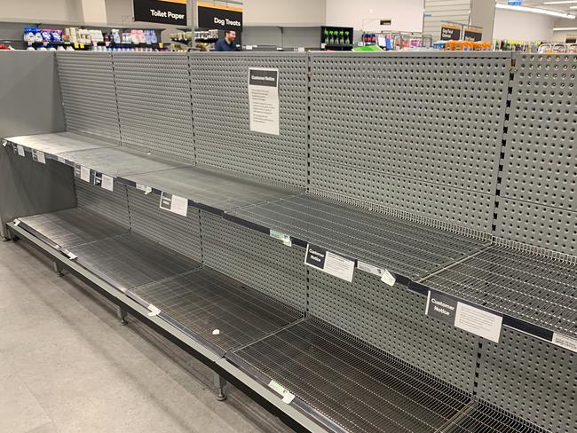 Empty shelves of toilet paper are seen at Woolworths Town Hall in Sydney, Friday, March 13, 2020. AAP Image/Bianca De Marchi) NO ARCHIVING