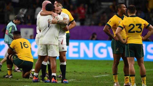 England players celebrate as the Wallabies come to terms with defeat after thir 2019 Rugby World Cup quarter-final at Oita Stadium. Picture: AFP