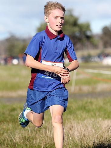 Sam Clifford of Riverside Primary School checks his time as he crosses the line first in the boys year 6 cross country.