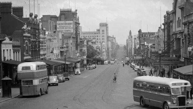 Double-decker and single-decker buses on Bourke St in the 1940s. Picture: Trove