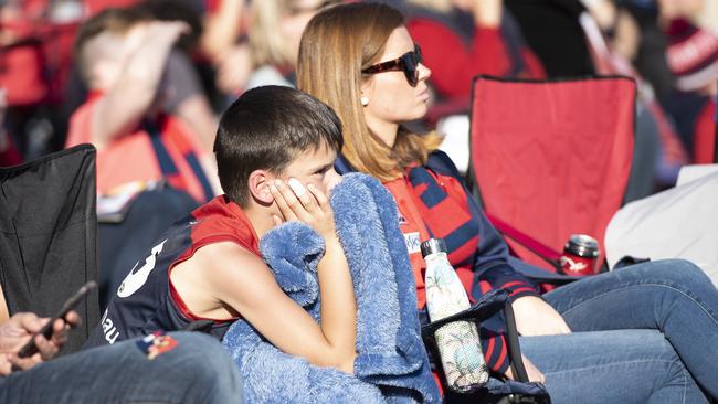 Demons fans watch on at Federation Square in Melbourne.