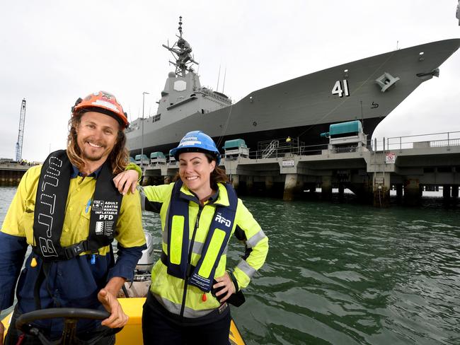 Rigger Trent Sadlier and forklift operator Jade Hills get a waterfront view of HMAS Brisbane. Picture: Tricia Watkinson.