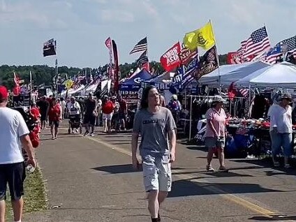 Thomas Crooks walks casually through Trump merchandise stalls hours before he attempted to assassinate the former US President. Picture: Supplied