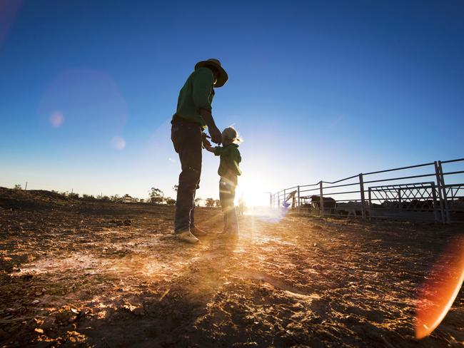 Cameron Tickell with daughter Sophie, 6, amid the harsh conditions. Picture: Nigel Hallett