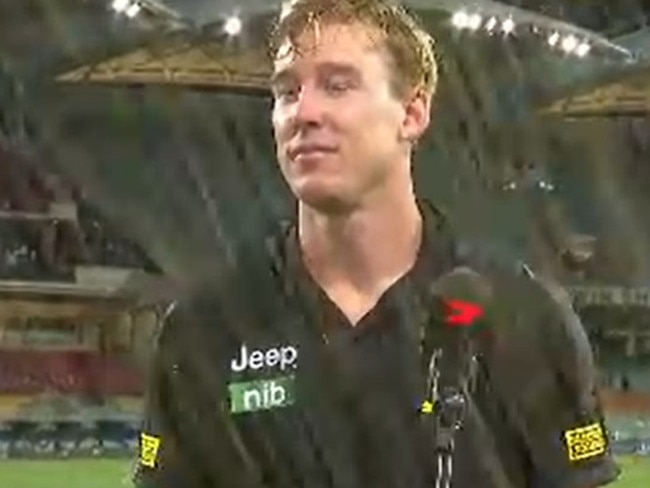 Tom Lynch is soaked by a drink thrown by a fan.