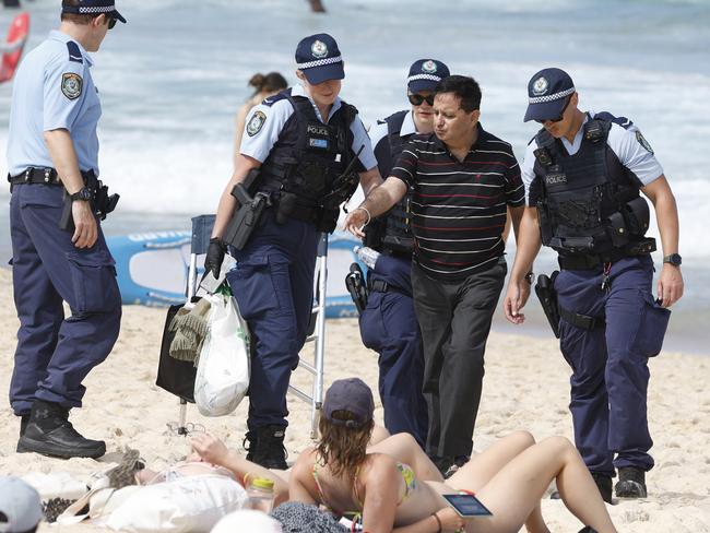 SYDNEY, AUSTRALIA - NewsWire Photos JANUARY 26, 2025: Police escort a man off the beach at Bronte Beach on Australia day.Picture: NewsWire / Damian Shaw