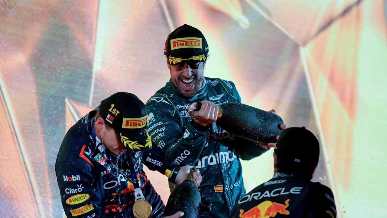 Third place winner Aston Martin's Spanish driver Fernando Alonso (C) sprays with non-alcoholic champagne (rosewater) race winner Red Bull Racing's Dutch driver Max Verstappen (L) on the podium after the Bahrain Formula One Grand Prix at the Bahrain International Circuit in Sakhir on March 5, 2023. (Photo by Giuseppe CACACE / AFP) / â&#128;&#156;The erroneous mention[s] appearing in the metadata of this photo has been modified in AFP systems in the following manner: [ADDS: non-alcoholic]. Please immediately remove the erroneous mention[s] from all your online services and delete it (them) from your servers. If you have been authorized by AFP to distribute it (them) to third parties, please ensure that the same actions are carried out by them. Failure to promptly comply with these instructions will entail liability on your part for any continued or post notification usage. Therefore we thank you very much for all your attention and prompt action. We are sorry for the inconvenience this notification may cause and remain at your disposal for any further information you may require.â&#128;&#157;
