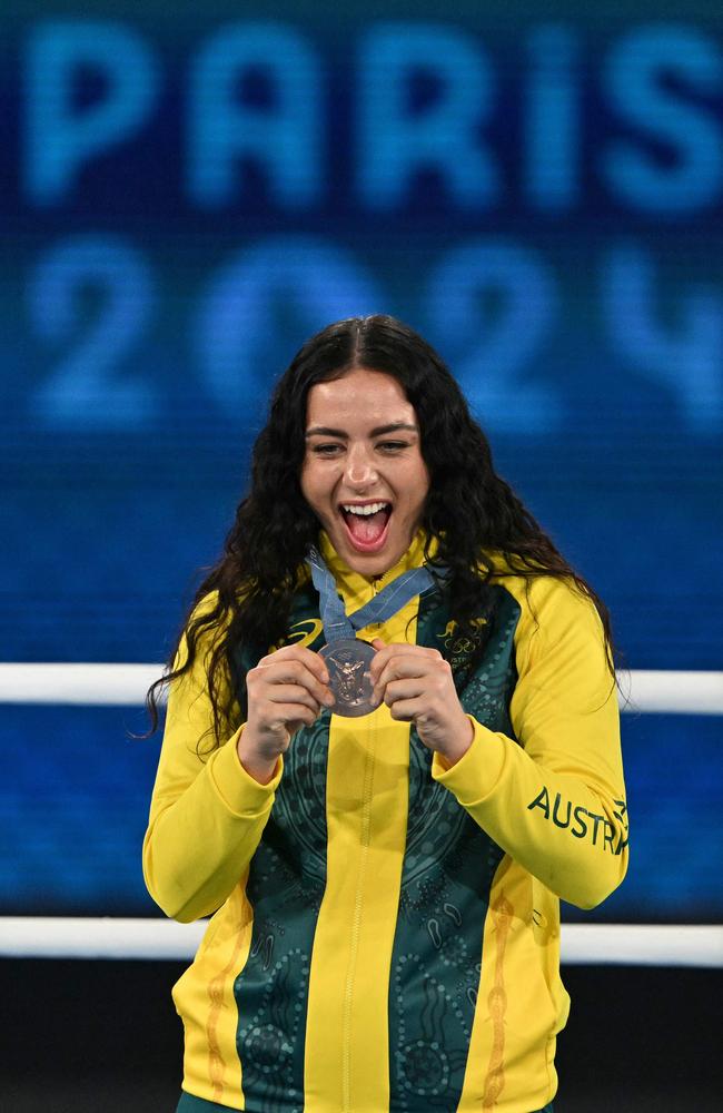 Caitlin Parker celebrates on the podium . (Photo by MOHD RASFAN / AFP)