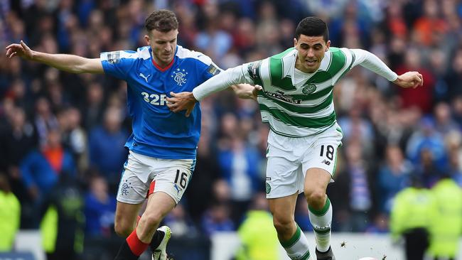 Andy Halliday of Rangers holds Tom Rogic.