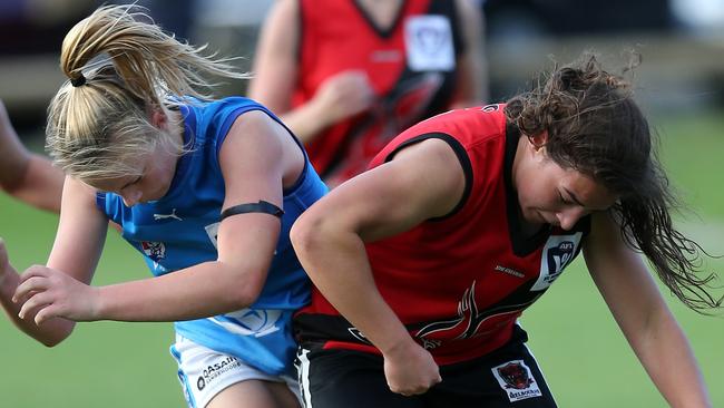 Ainslie Kemp (pictured left) lays a bump playing for VU Western Spurs in the VFL Women’s competition. Picture Yuri Kouzmin.