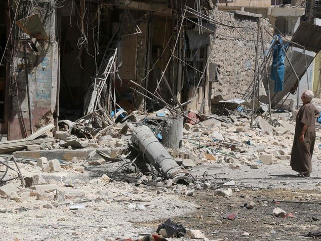 A resident of the Tariq al-Bab neighbourhood of Aleppo, inspects the damage caused by air raids. Picture: AFP/THAER MOHAMMED